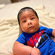 Kaiden is registered to the contest to win money with this photo: baby, bed, bedroom, blanket, bodypart, clothing, couch, face, finger, furniture, hand, happy, head, indoors, newborn, person, photography, portrait, smile, t_shirt