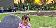 Arabella joined the competition — help win amazing prizes! toddler, child, park, sunset, grass, playground, purple, outdoor, trees, sky, clouds, building, bench, people, funny_face, clothing, nature, recreation, daylight, cute