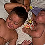 Arabella is registered to the contest to win money with this photo: child, toddler, baby, sleeping, smiling, bed, blanket, diaper, indoor, family, cute, resting, hugging, pajamas, person, young, cozy, playful, infant, sibling