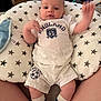 Jasper joined the competition — help win amazing prizes! baby, infant, child, white_clothing, socks, pillow, stars_pattern, indoor, person, legs, hands, face, eyes, shorts, tshirt, couch, home, toy, blanket, comfortable