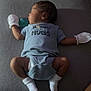 baby, sleeping, onesie, mittens, socks, pacifier, infant, child, resting, cute, indoors, soft_lighting, fabric, texture, peaceful, newborn, person, lying_down, cozy, toddler