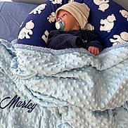 Marley participe au concours pour gagner de l'argent avec cette photo : baby, blanket, pacifier, hat, blue, bed, pillow, bear_pattern, infant, cozy, sleepwear, child, cute, soft, resting, newborn, comfort, indoors, portrait, warm