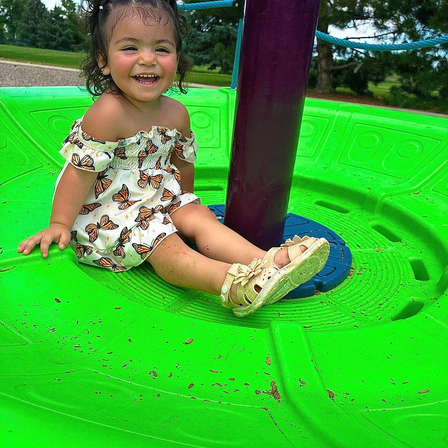 Leonicia joined the competition — help win amazing prizes! butterfly, child, curly_hair, dress, fun, grass, green, hair_bows, happy, nature, outdoor, park, play, playground, sandals, smiling, spinning_toy, summer, toddler, trees