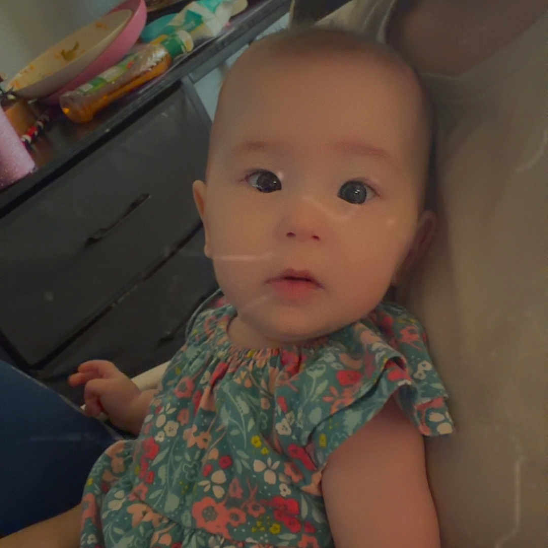 Alina joined the competition — help win amazing prizes! adult, arm, baby, casual, child, closeup, clothing, curious, dresser, face, floral_dress, furniture, hand, holding, indoor, person, piercing, portrait, poster, skin