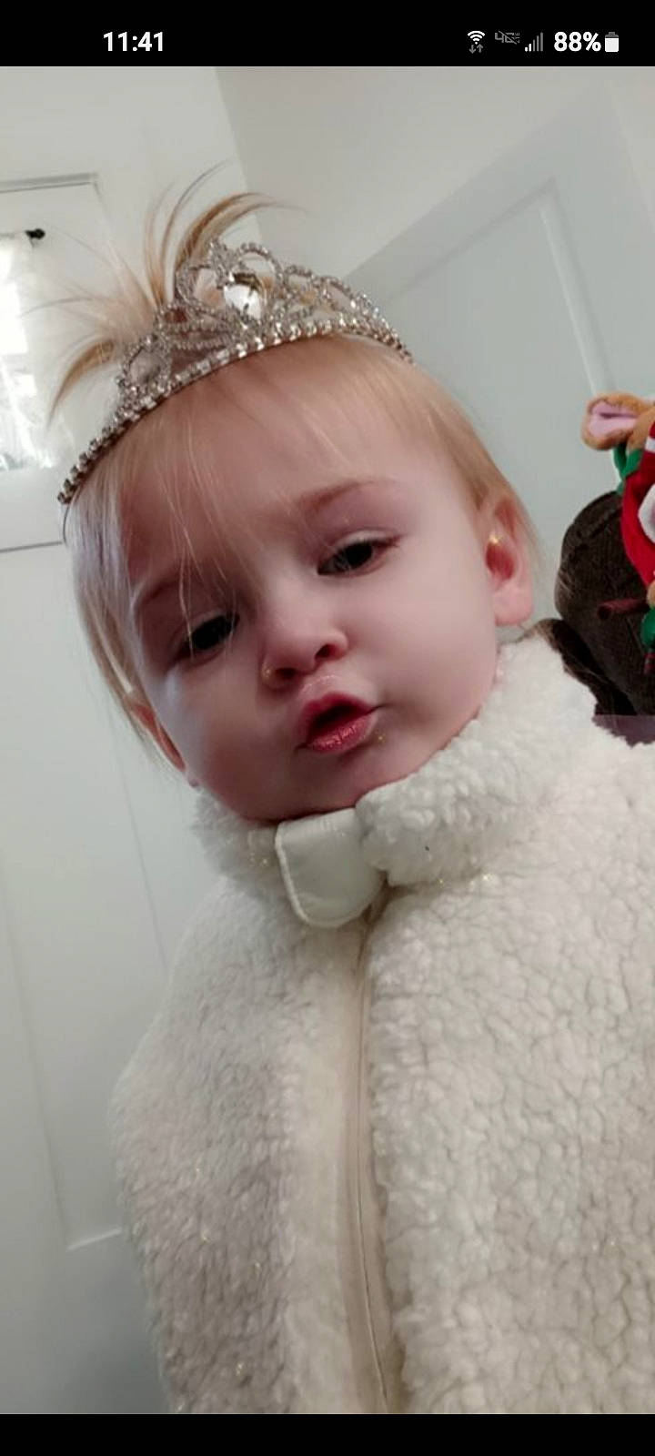 Bella joined the competition — help win amazing prizes! bridal_accessory, chin, costume_hat, embellishment, event, eyebrow, eyelash, hair_accessory, happy, head, headband, headgear, headpiece, jewellery, lip, person, pink, sleeve, tiara, toddler