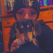Zara joined the competition — help win amazing prizes! beanie, black_coat, bottles, cute, dog, drawers, dresser, eyelashes, hand, hat, holding, indoor, mirror, person, pet, portrait, puppy, selfie, shelf, wooden_furniture