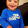 Seth Williams is registered to the contest to win money with this photo: apparel, baby, blue_clothing, candid, child, cute, dimples, face, happy, human, indoors, joyful, long_sleeve, person, portrait, sitting, smile, toddler, warm_lighting, young_child