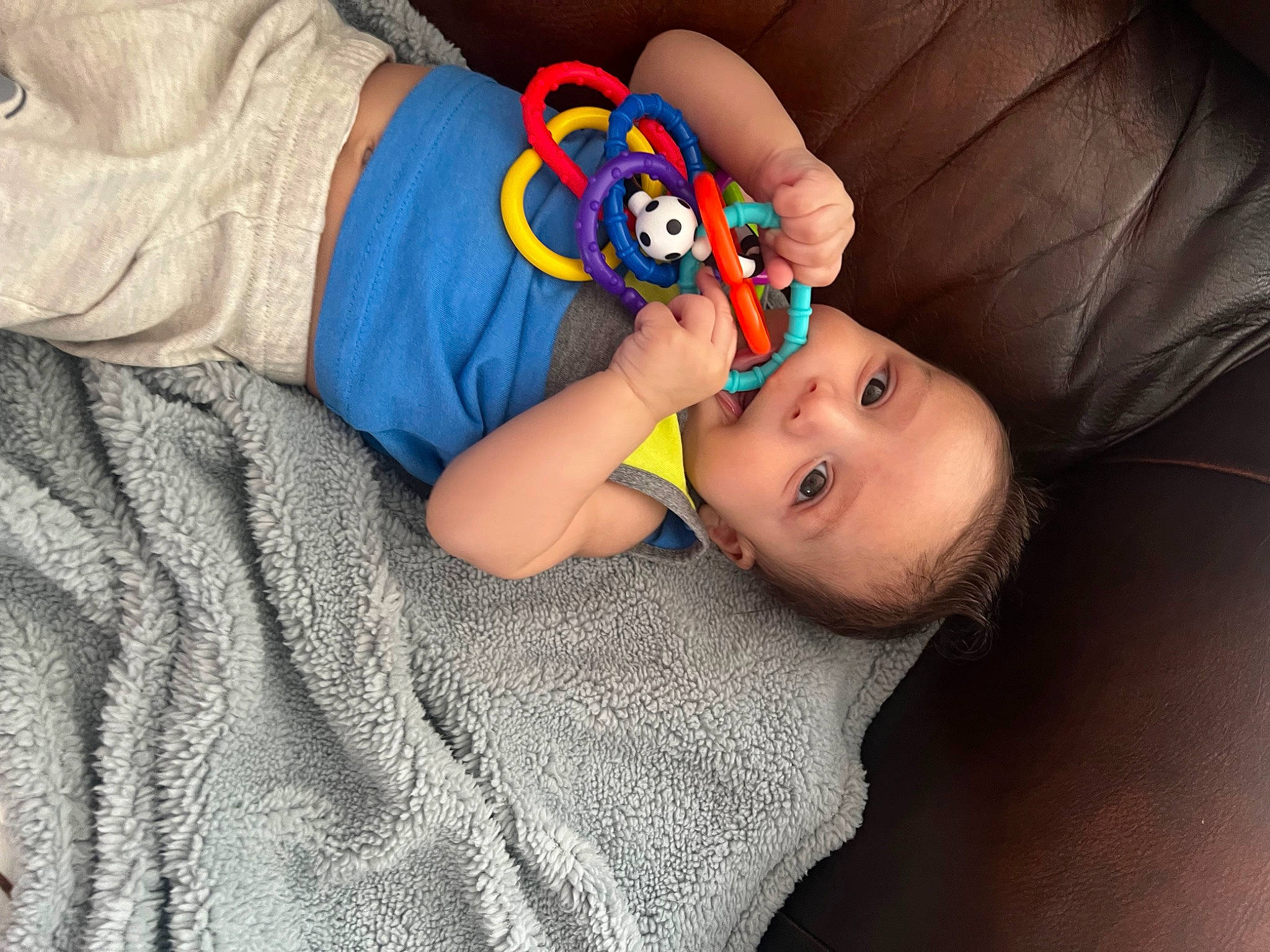 David is registered to the contest to win money with this photo: baby, baby_products, baby_toddler_clothing, cheek, child, comfort, finger, flooring, fun, nail, nose, pattern, person, room, sitting, skin, sleeve, thumb, toddler, wood