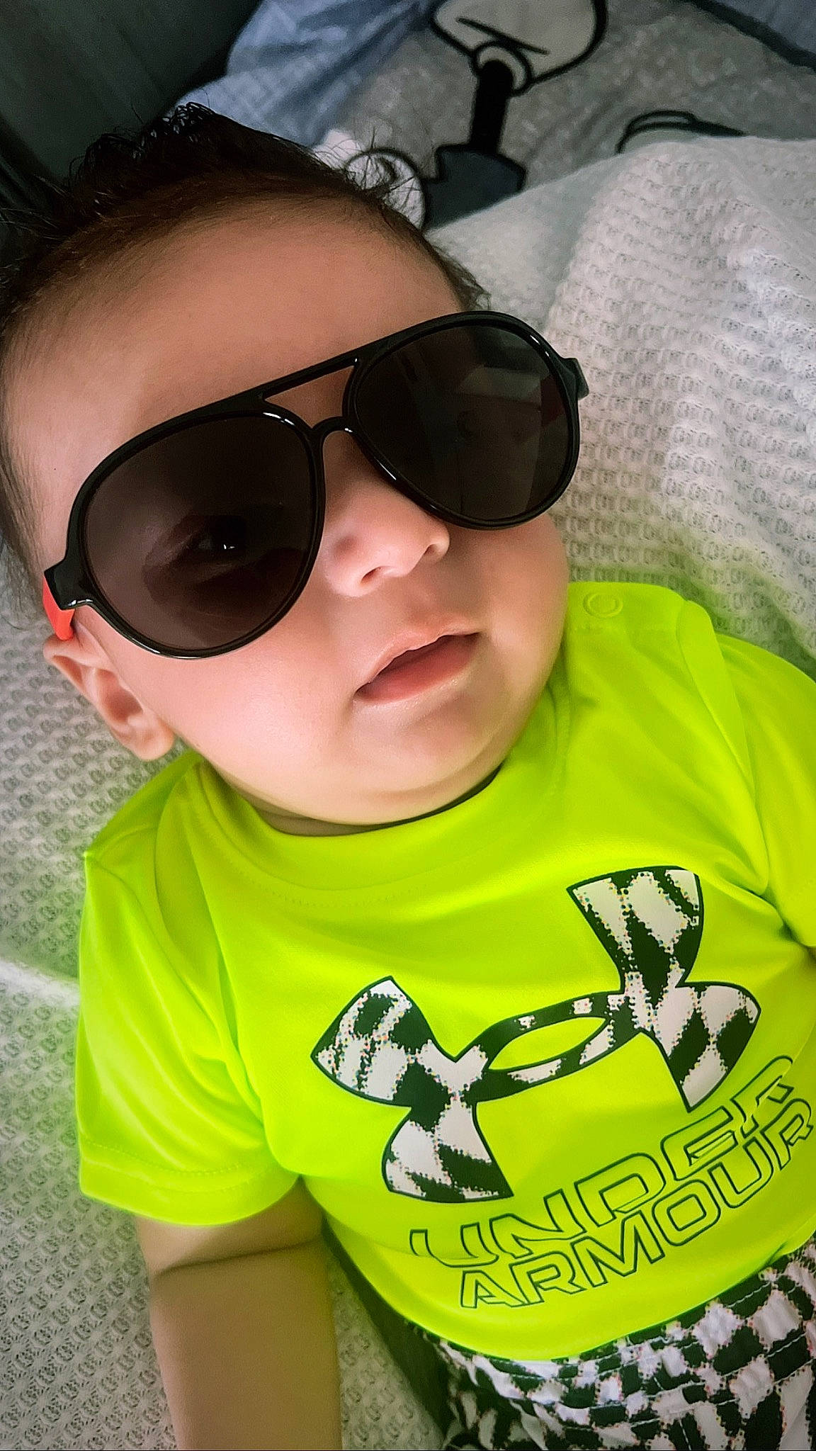 David is registered to the contest to win money with this photo: baby_toddler_clothing, cheek, child, clothing, cool, eye_glass_accessory, eyewear, goggles, grass, happy, lip, mouth, person, personal_protective_equipment, sleeve, sunglasses, t_shirt, toddler, vision_care, white