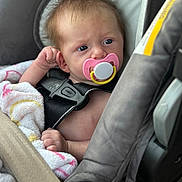 Luna joined the competition — help win amazing prizes! baby, pacifier, car_seat, blanket, child, infant, seatbelt, straps, closeup, face, skin, hair, hand, indoor, safety, transportation, cute, young, expression, comfort