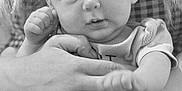 Luna joined the competition — help win amazing prizes! baby, infant, black_and_white, hand, tattoo, person, cute, portrait, child, holding, face, eyes, hair, skin, clothing, adult, arm, expression, closeup, toddler