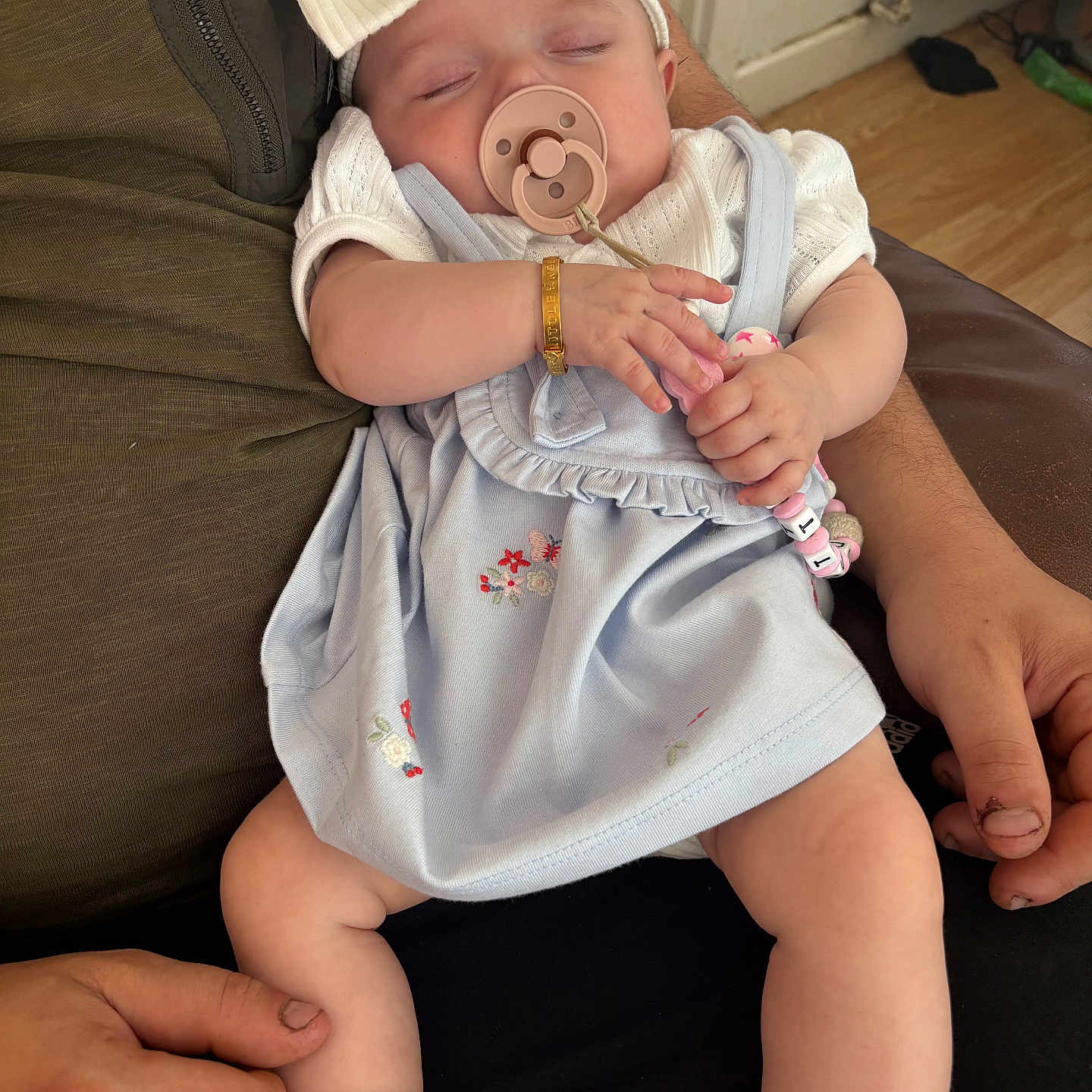Dottie Sue joined the competition — help win amazing prizes! adult_hand, baby, blue_dress, bow, bracelet, child, closeup, couch, flooring, frills, hands, headband, indoor, infant, legs, pacifier, person, radiator, sleeping, socks