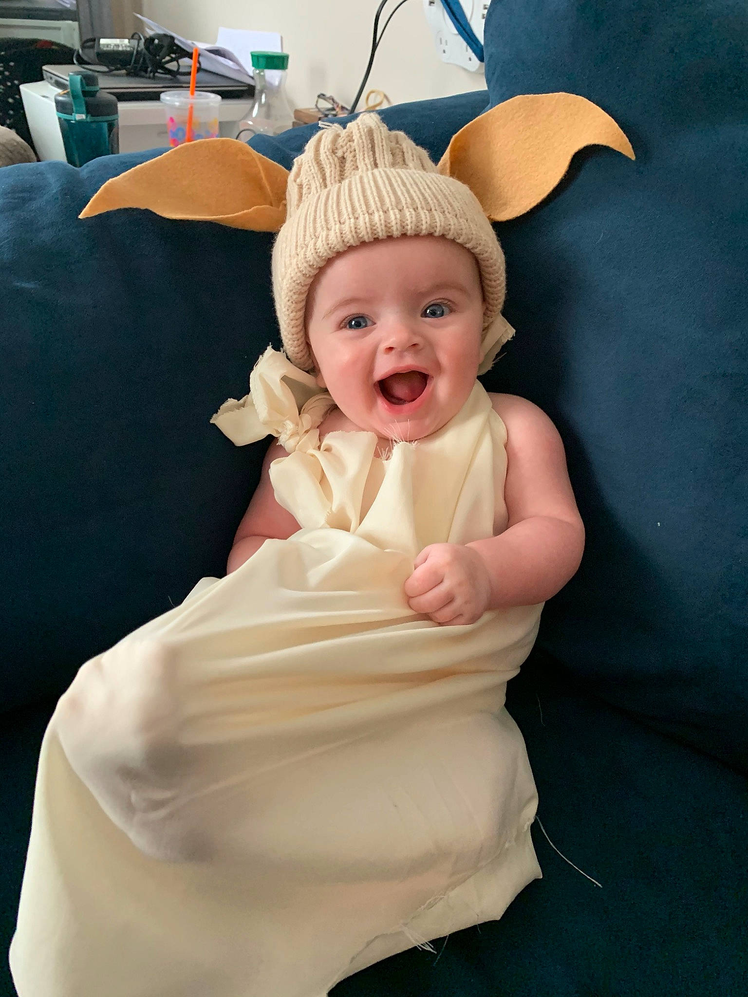 Zia joined the competition — help win amazing prizes! baby, blond, child, dress, ear, fashion_accessory, hair_accessory, head, headgear, headwear, human_body, organ, person, product, skin, smile, toddler, white