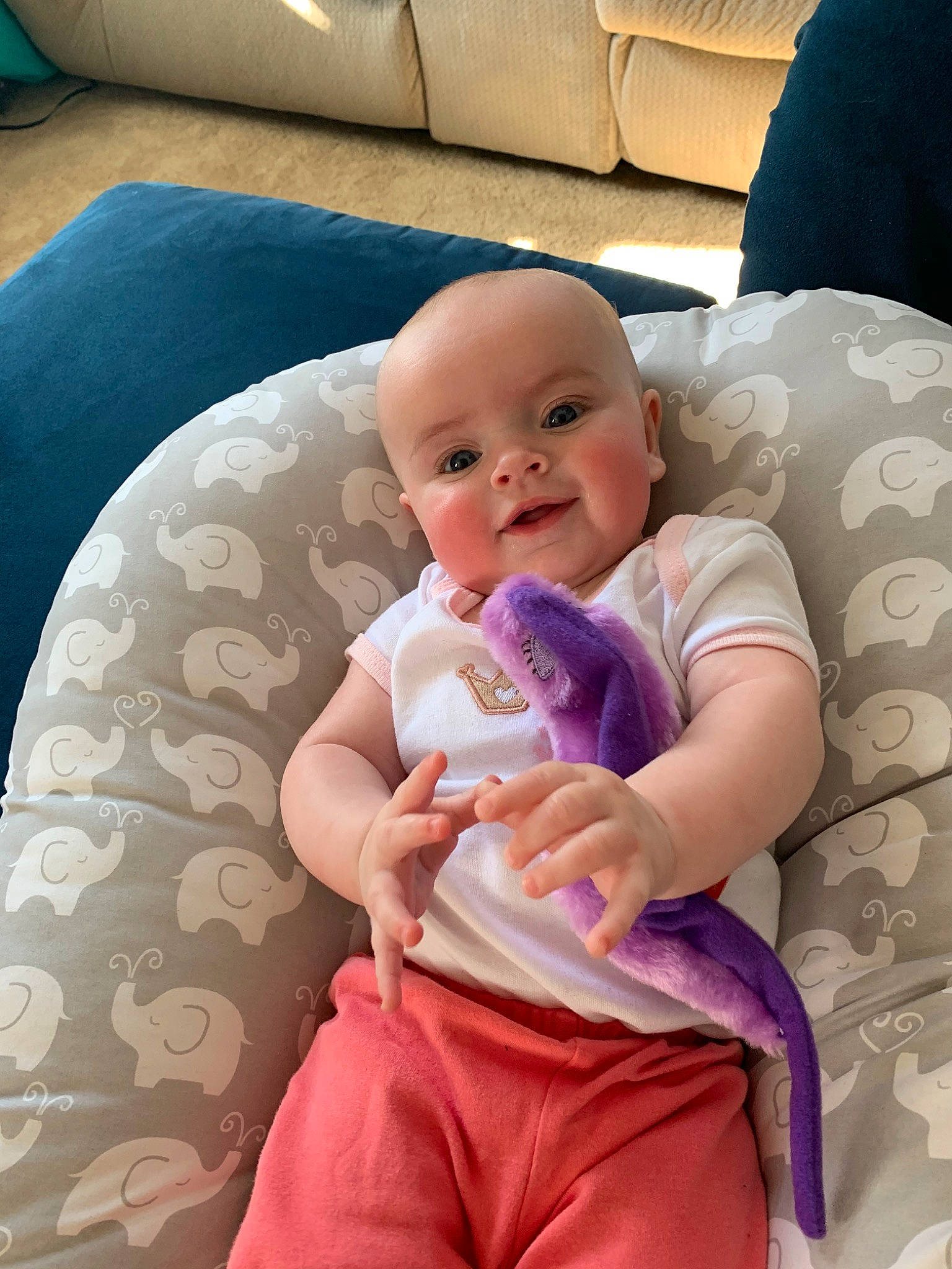 Zia is registered to the contest to win money with this photo: abdomen, baby, baby_products, birth, child, comfort, finger, hand, lap, leg, person, pink, product, sitting, skin, textile, toddler, vacation