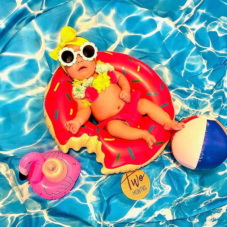 Emma joined the competition — help win amazing prizes! accessories, baby, balloon, cap, clothing, face, hat, head, jewelry, necklace, people, person, photography, pool, portrait, summer, sunglasses, swimmingpool, swimwear, water