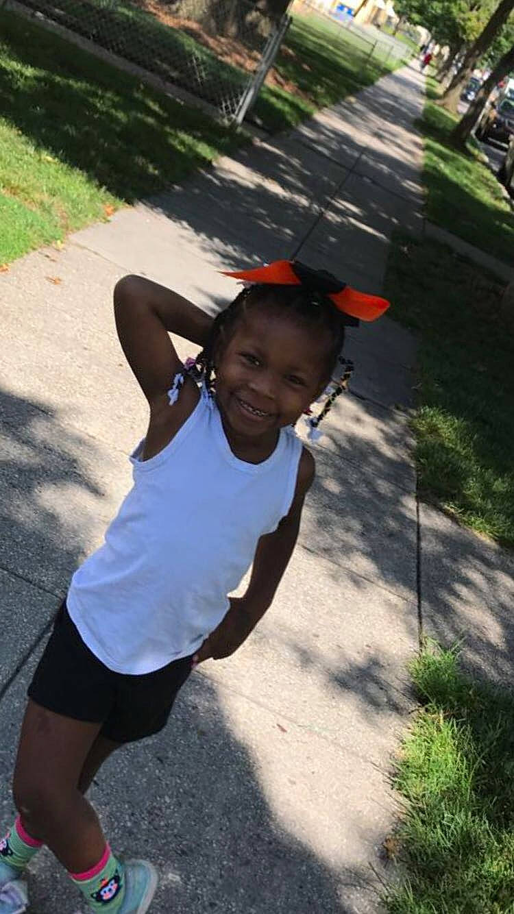 Lavonna is registered to the contest to win money with this photo: asphalt, baseball_cap, black_hair, electric_blue, fun, grass, happy, hat, joy, leaf, leisure, person, plant, recreation, road, shorts, sidewalk, smile, t_shirt, toddler