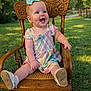 Ella is registered to the contest to win money with this photo: baby, infant, rocking_chair, wooden_chair, bow, headband, pastel_dress, smile, happy, sitting, outdoor, grass, portrait, cute, shoe, one_person, child, sunlight, backyard, chair_carving