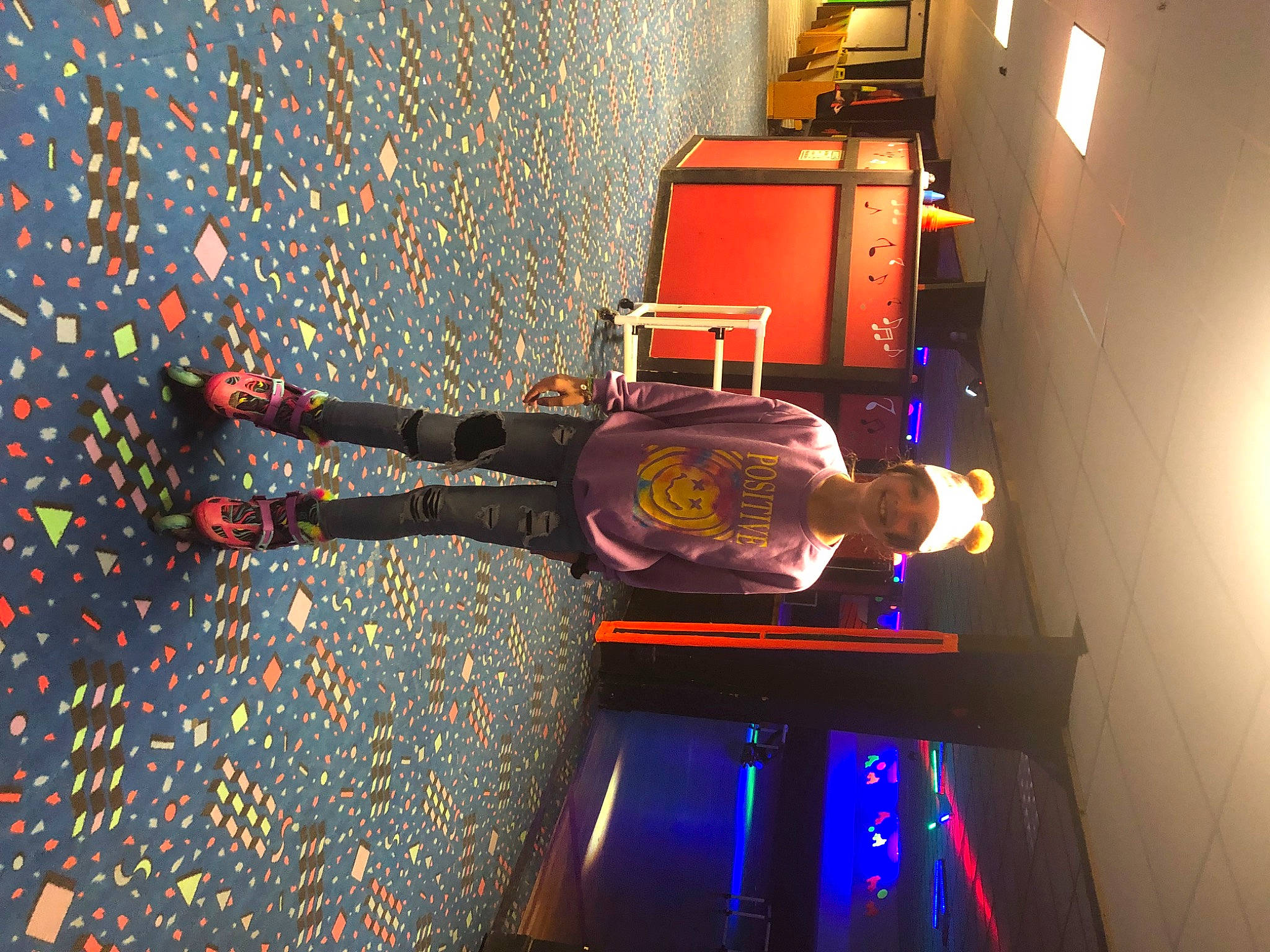 Piper is registered to the contest to win money with this photo: display_device, electric_blue, entertainment, event, fun, indoor_games_and_sports, joy, light, machine, magenta, pattern, performing_arts, person, room, space, visual_effect_lighting