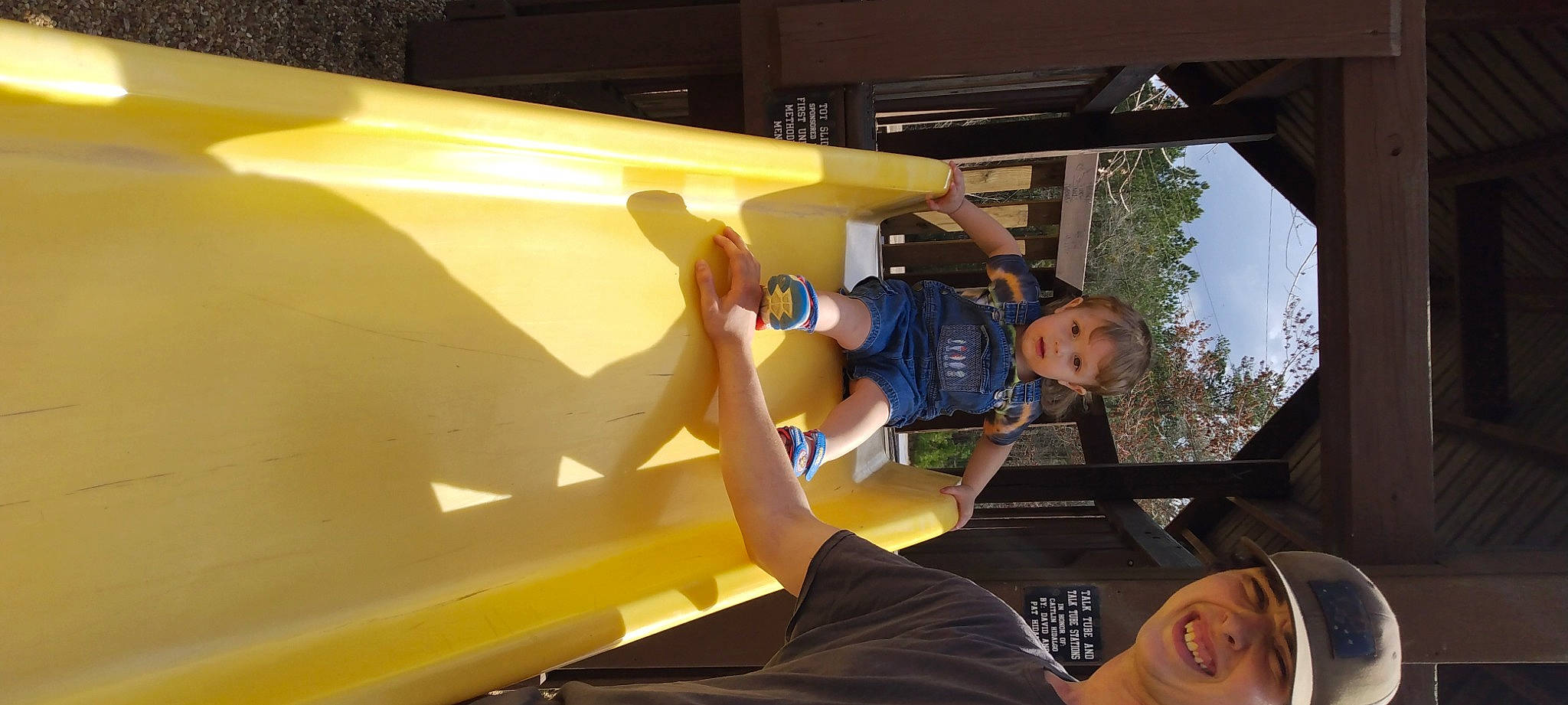 Wyatt is registered to the contest to win money with this photo: adventure, automotive_exterior, ceiling, fun, headwear, joy, landscape, leisure, person, plant, recreation, room, shorts, sky, smile, t_shirt, travel, tree, yellow