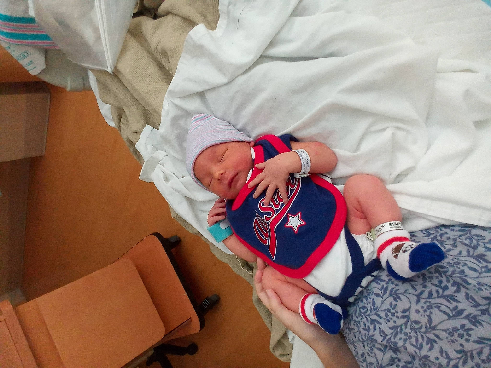 Jamison joined the competition — help win amazing prizes! baby, baby_sleeping, carmine, child, comfort, elbow, event, hat, headwear, health_care, human_body, human_leg, knee, linens, person, room, sleeve, textile, thigh, thumb