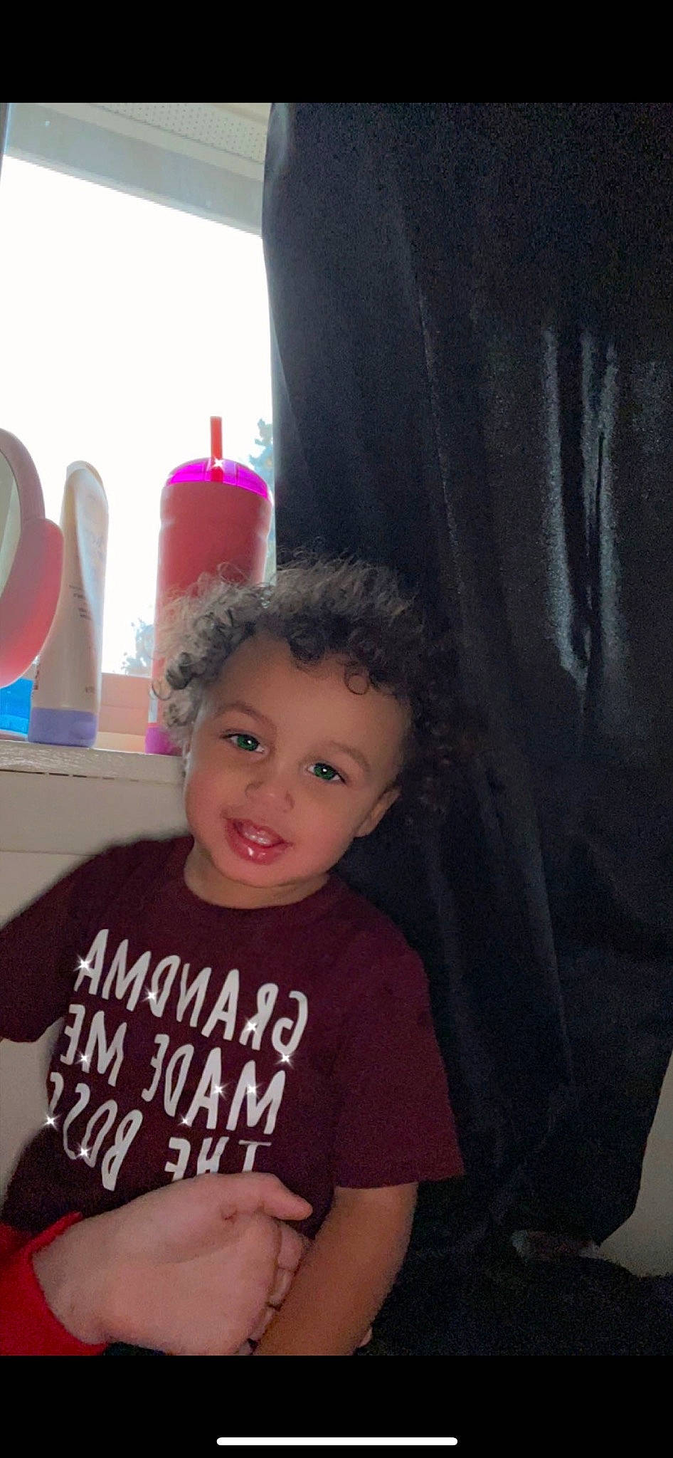Legend is registered to the contest to win money with this photo: baby_toddler_clothing, cheek, child, curtain, fun, happy, magenta, neck, party_supply, person, purple, room, shoulder, sitting, sleeve, smile, t_shirt, toddler, top, vacation