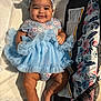 baby, child, smiling, blue_dress, headband, cushion, fabric, indoor, cute, infant, happy, person, skin, legs, arms, sitting, portrait, clothing, comfort, baby_girl