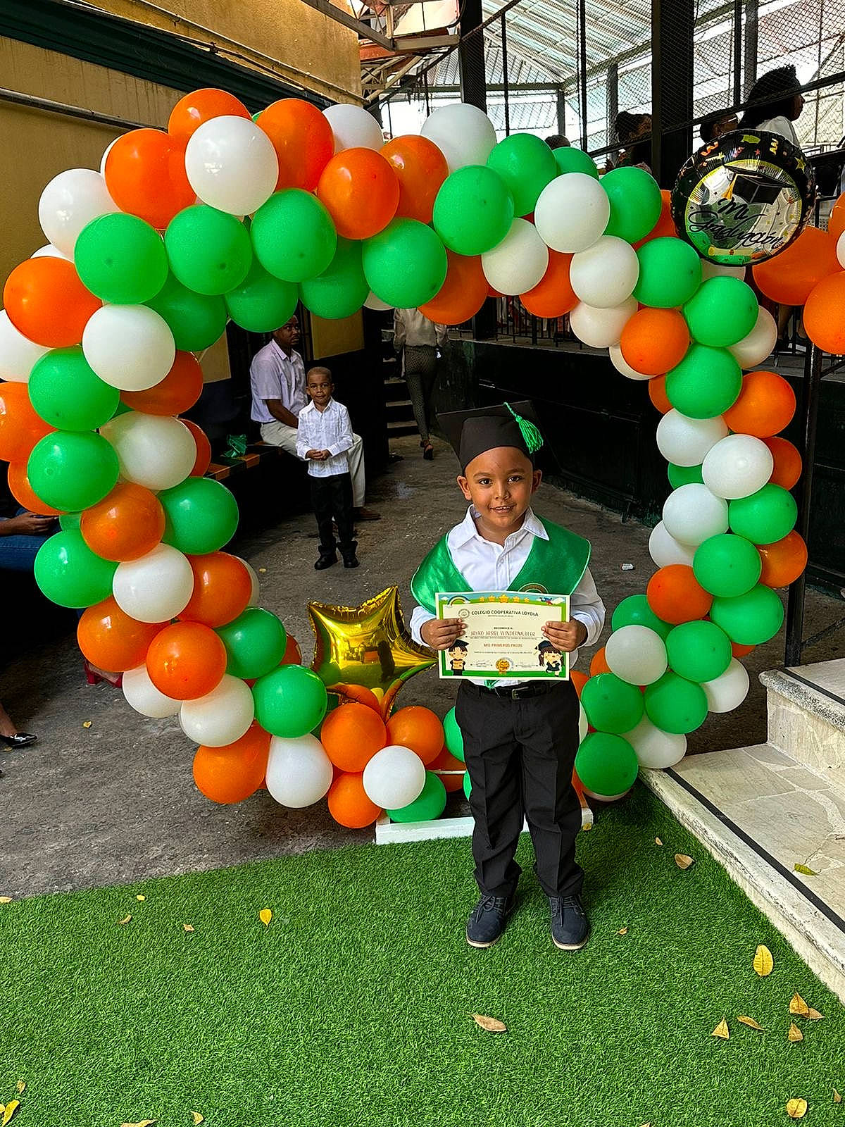 Jayko is registered to the contest to win money with this photo: arch, balloon, community, event, fun, grass, green, happy, headwear, jeans, joy, leisure, local_food, natural_environment, orange, party_supply, person, plant, public_space, recreation