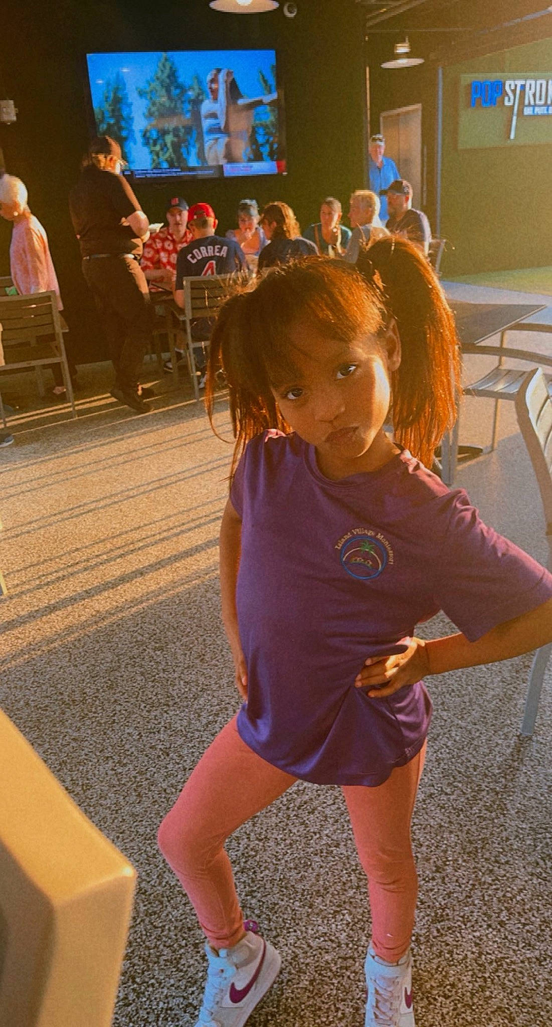 Amani is registered to the contest to win money with this photo: chair, entertainment, event, facial_expression, fashion, floor, flooring, fun, happy, human_leg, joint, leg, leisure, long_hair, person, public_space, shoulder, snapshot, sportswear, thigh