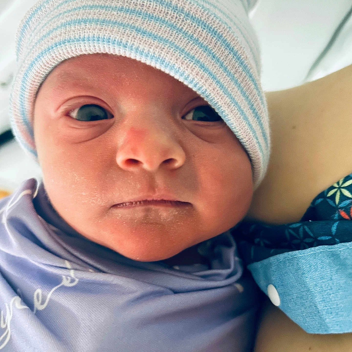 Tylee is registered to the contest to win money with this photo: newborn, baby, infant, face, headwear, hat, swaddled, blanket, portrait, closeup, person, skin, expression, indoors, young_child, cute, sleepwear, newborn_clothing, baby_face, human