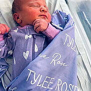 Tylee is registered to the contest to win money with this photo: newborn, baby, sleeping, blanket, purple, clothing, infant, bed, peaceful, face, hand, person, portrait, soft, cute, cozy, resting, indoor, toddler, child