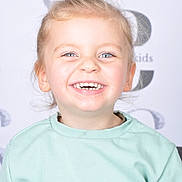 Tyler a rejoint le concours — aidez-le/la à gagner de superbes lots ! blond_hair, blue_eyes, casual_clothing, child, cute, expression, face, happy, head_and_shoulders, indoors, joyful, light_background, mint_green, person, portrait, smiling, studio, sweater, teeth, young