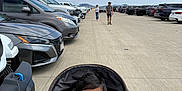 Ram joined the competition — help win amazing prizes! baby, stroller, parking_lot, car, sidewalk, child, person, outdoor, sky, cloud, road, vehicle, casual_clothing, seat_belt, head, face, walking, summer, sunny, people