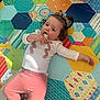 Sabrina joined the competition — help win amazing prizes! toddler, child, snack, pigtails, hair_bows, colorful_mat, play_mat, book, illustration, pink_pants, white_shirt, indoor, relaxed, lying_down, food, toy, pattern, hexagonal, cute, casual