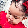 toddler, child, red_dress, red_bows, curly_hair, necklace, portrait, outdoor, close_up, face, cute, young_child, fashion, happy, person, skin, eyelashes, hair, head, expression