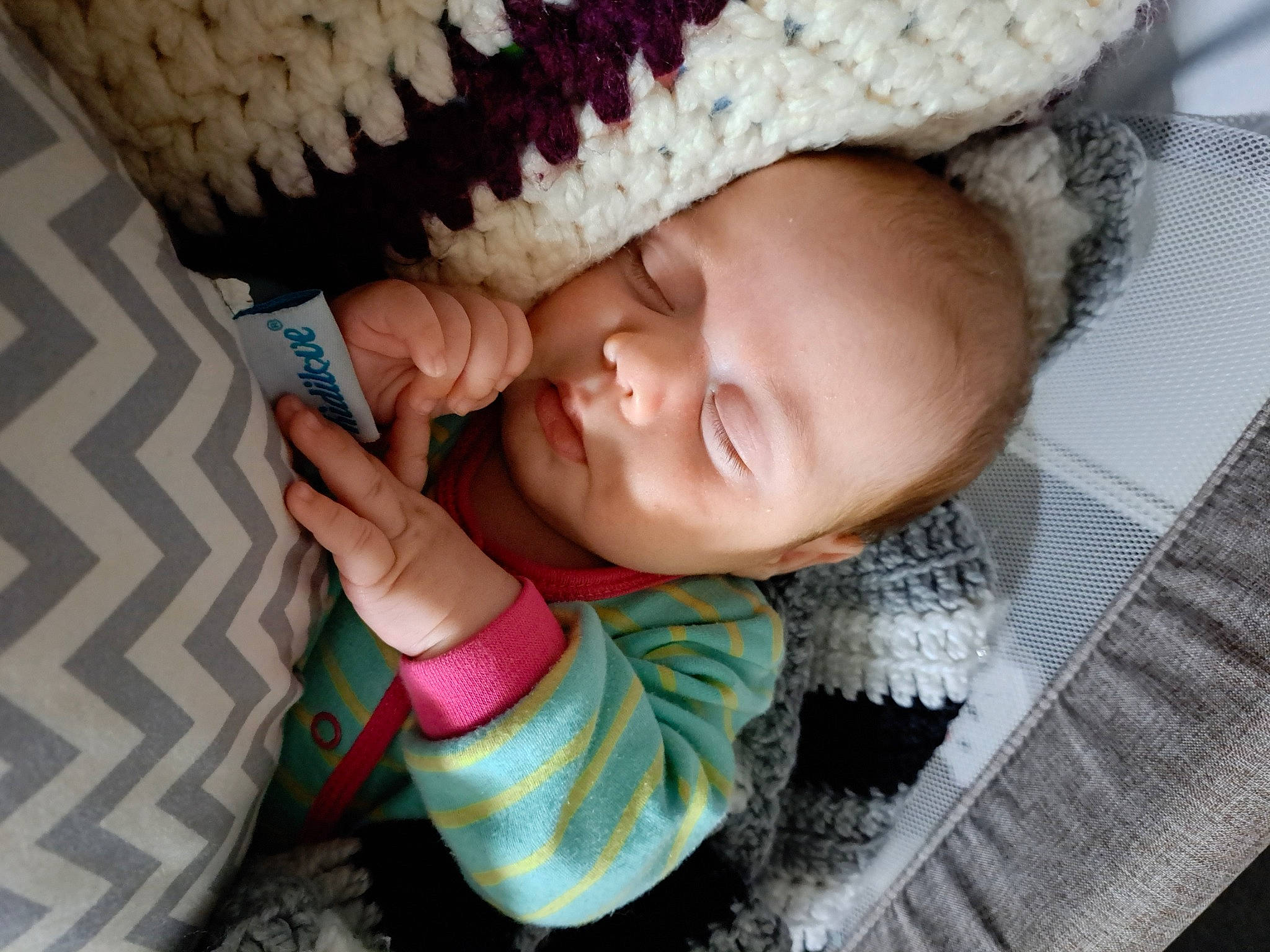 Evanah participe au concours pour gagner de l'argent avec cette photo : baby, baby_products, baby_toddler_clothing, cap, cheek, child, comfort, eyelash, finger, hand, happy, headgear, knit_cap, lip, nose, pattern, person, pink, skin, smile