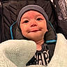 baby, blanket, beanie, smile, face, child, stroller, clothing, cozy, infant, portrait, indoor, cute, warm, soft, headwear, happy, babyface, closeup, comfort