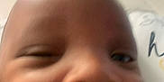 Amiri joined the competition — help win amazing prizes! baby, closeup, face, smile, indoor, child, infant, joy, expression, head, skin, portrait, happy, one_eye_closed, candid, blurry, human, person, baby_clothing, cheeks