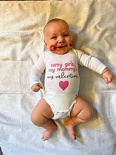 King is registered to the contest to win money with this photo: baby, baby_toddler_clothing, cheek, comfort, eye, face, finger, gesture, happy, head, human_body, joy, linens, nose, person, product, skin, sleeve, smile, t_shirt