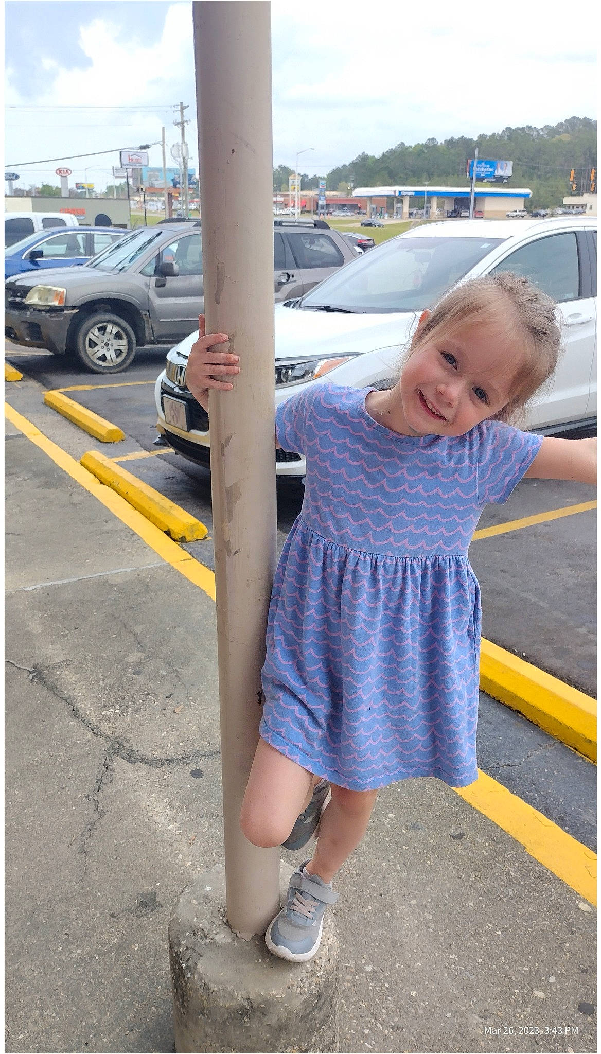 Cheyann joined the competition — help win amazing prizes! asphalt, automotive_design, automotive_exterior, automotive_tire, car, electric_blue, human_leg, joy, motor_vehicle, parking, person, road, road_surface, sidewalk, sky, smile, standing, tire, toddler, vehicle