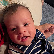Isaac is registered to the contest to win money with this photo: baby, infant, face, smile, striped_clothing, portrait, closeup, hand, skin, person, young_child, cute, expression, indoors, human, newborn, child, head, eyes, sleeve