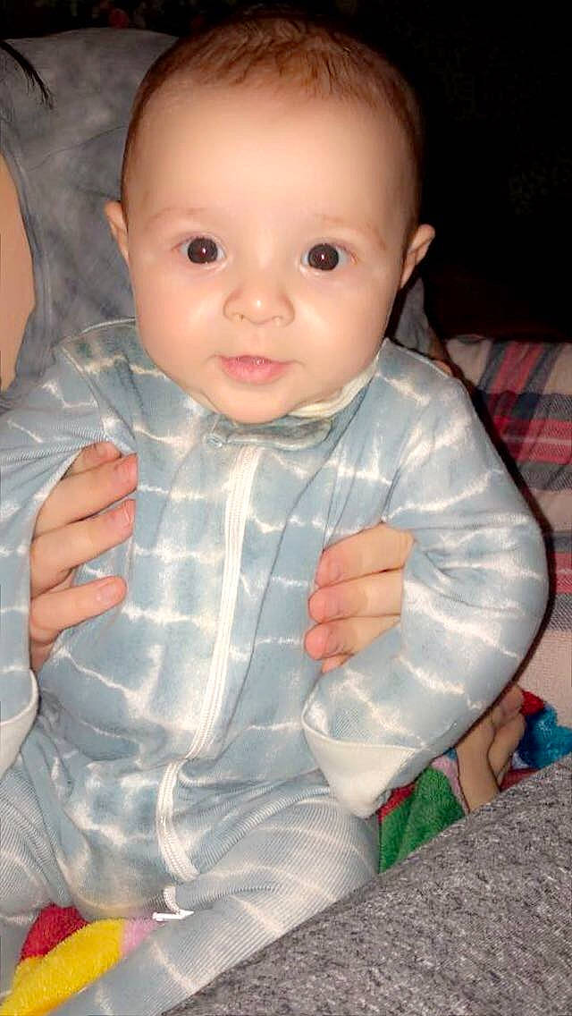 Ryder is registered to the contest to win money with this photo: arm, baby, baby_toddler_clothing, cheek, eye, eyebrow, finger, fruit, gesture, hand, human_body, iris, lip, mouth, nose, person, product, skin, sleeve, thumb