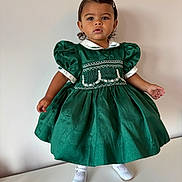 Aniya joined the competition — help win amazing prizes! toddler, child, green_dress, white_shoes, hair_clip, portrait, standing, curious, indoor, fashion, vintage_style, puffed_sleeves, cute, young_child, person, studio, innocence, elegant, minimal_background, footwear