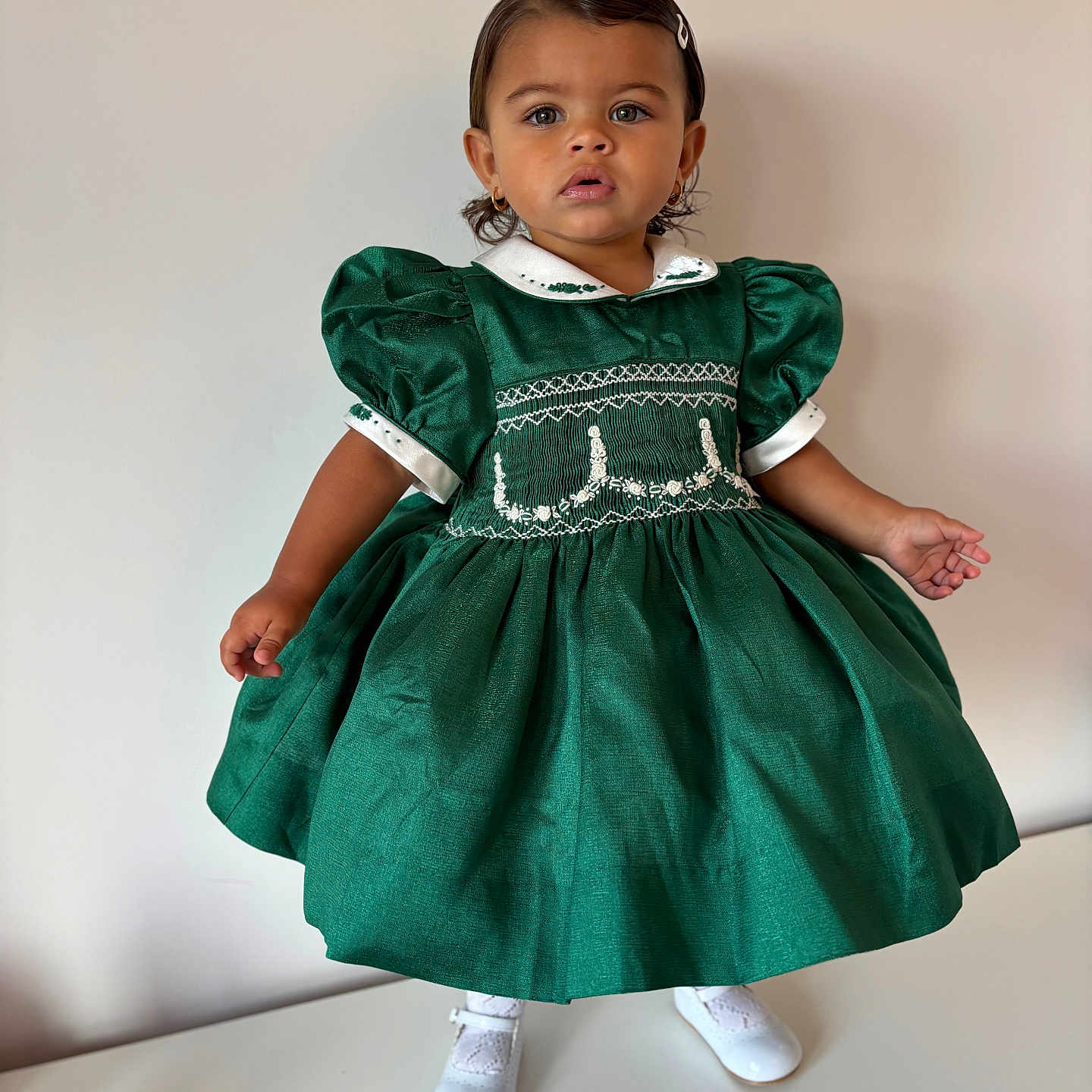 Aniya joined the competition — help win amazing prizes! child, curious, cute, elegant, fashion, footwear, green_dress, hair_clip, indoor, innocence, minimal_background, person, portrait, puffed_sleeves, standing, studio, toddler, vintage_style, white_shoes, young_child
