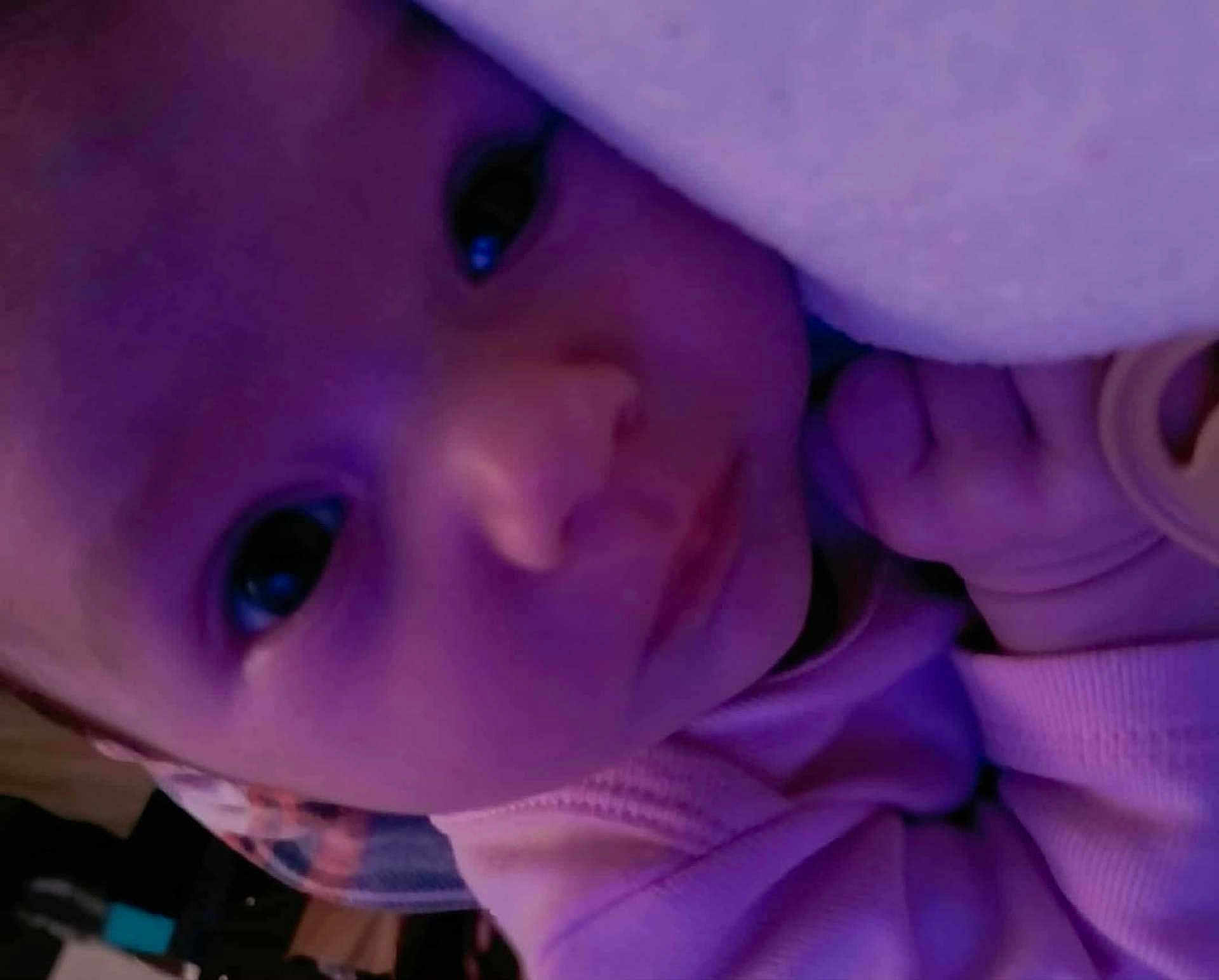 Lyvia joined the competition — help win amazing prizes! baby, blanket, child, close_up, cozy, cute, expression, eyes, face, hand, head, indoors, infant, portrait, purple_light, skin, sleepy, soft, wearing_clothes, young