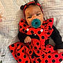 baby, child, costume, ladybug, red, black, polka_dot, pacifier, headband, infant, cute, lying_down, blanket, clothing, portrait, indoors, sleeves, hand, face, expression