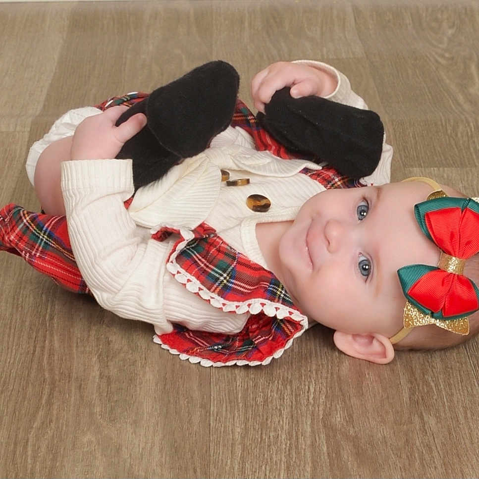 Elliana is registered to the contest to win money with this photo: accessories, baby, bodypart, clothing, coat, dress, face, finger, hand, hardwood, hat, head, jacket, knitwear, pants, person, photography, portrait, sweater, wood