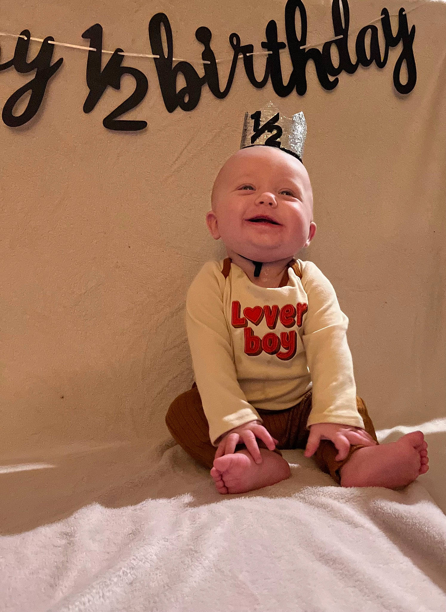 Izaiah is registered to the contest to win money with this photo: art, baby, baby_toddler_clothing, carmine, child, fictional_character, finger, flooring, font, fun, happy, illustration, peach, person, photo_caption, sitting, sleeve, smile, t_shirt, thumb