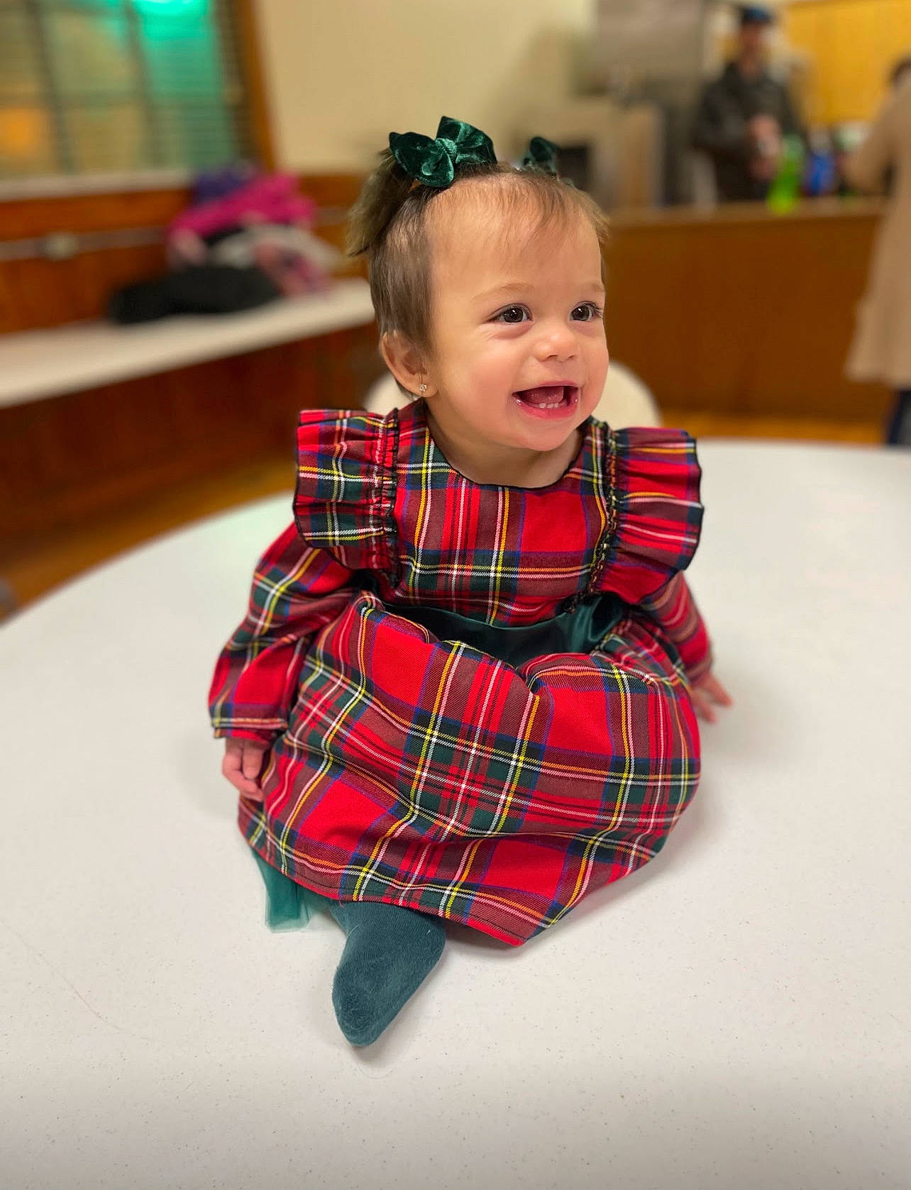 Amaya is registered to the contest to win money with this photo: baby, baby_toddler_clothing, child, collar, event, fashion_accessory, flooring, fun, happy, pattern, person, plaid, plant, room, sitting, sleeve, smile, tartan, textile, toddler