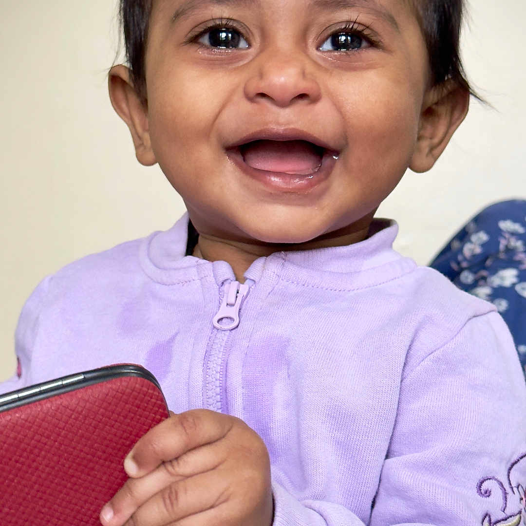 Pranikanvika is registered to the contest to win money with this photo: accessories, baby, babylaughing, bodypart, clothing, face, finger, hand, happy, head, knitwear, laughing, longsleeve, person, photography, portrait, sleeve, smile, sweater, wallet