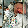 newborn, baby, sleeping, hospital, bassinet, blanket, clothing, gray_outfit, minnie_mouse, unicorn, rainbow, cute, infant, cozy, resting, face, hand, soft_light, child, indoors